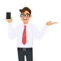 Young business man showing new brand, latest smartphone. Man holding cell, mobile phone in hand and gesturing/presenting hand palm