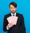 Young business man showing playing cards