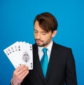 Young business man showing playing cards -