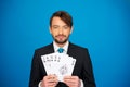 Young business man showing playing cards