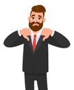 Young business man showing thumbs down sign, dislike, looks withYoung business man showing thumbs down sign, dislike, looks with n Royalty Free Stock Photo