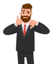 Young business man showing thumbs up and thumbs down gesture. Like and dislike. Agree and disagree. Royalty Free Stock Photo