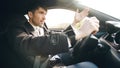 Young business man driving car very upset and stressed after hard failure and moving in traffic jam Royalty Free Stock Photo