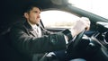 Young business man driving car very upset and stressed after hard failure and moving in traffic jam Royalty Free Stock Photo