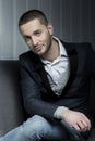 Young business man sitting on a chair and looking at the camera Royalty Free Stock Photo