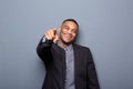 Young business man smiling and pointing finger Royalty Free Stock Photo