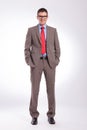 Young business man standing with both hands in pockets Royalty Free Stock Photo