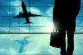 Young business Man Standing In Front of Airport window View. Man inside Airport hall with windows glass Royalty Free Stock Photo