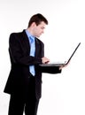 Young business man standing with laptop Royalty Free Stock Photo