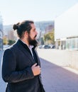 Young business man standing next to the offices