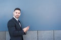 Young business man on a suit with the mobile phone Royalty Free Stock Photo