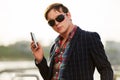 Young business man in sunglasses with a mobile phone Royalty Free Stock Photo