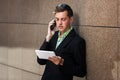 Young business man with tablet computer calling on phone Royalty Free Stock Photo