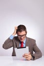 Young business man with tablet scratches his head Royalty Free Stock Photo