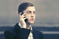 Young business man talking on mobile phone in city street Royalty Free Stock Photo