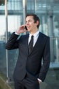 Young business man talking on mobile phone outdoors Royalty Free Stock Photo