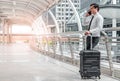 business man man on business trip standing with his luggage and making a call outside airport. Business traveler making Royalty Free Stock Photo