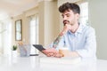 Young business man using touchpad tablet serious face thinking about question, very confused idea Royalty Free Stock Photo