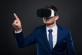 Young business man with VR glasses pointing at copyspace Royalty Free Stock Photo