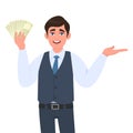 Young business man in waistcoat showing cash, money or currency notes and presenting hand to copy space. Person holding banknotes.