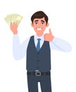 Young business man in waistcoat showing cash, money and gesturing thumbs up sign. Trendy person holding currency notes. Royalty Free Stock Photo