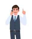 Young business man in waistcoat speaking on the phone and pointing finger up. Trendy person calling to mobile. Idea, solution. Royalty Free Stock Photo