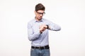 Young business man wearing glasses looking at watch over white background Royalty Free Stock Photo