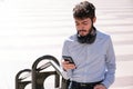 Young business man wearing headphones and using his smartphone Royalty Free Stock Photo