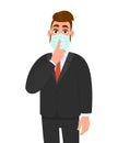 Young business man wearing medical mask and asking silence. Trendy hipster person gesturing finger on lips. Male character Royalty Free Stock Photo