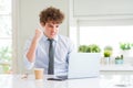 Young business man working with computer laptop at the office annoyed and frustrated shouting with anger, crazy and yelling with Royalty Free Stock Photo