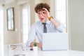 Young business man working with computer laptop at the office doing ok gesture shocked with surprised face, eye looking through Royalty Free Stock Photo