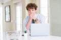 Young business man working with computer laptop at the office shocked covering mouth with hands for mistake Royalty Free Stock Photo