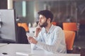 Young business man working on desktop computer at his desk in modern bright startup office interior Royalty Free Stock Photo