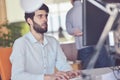 Young business man working on desktop computer at his desk in modern bright startup office interior Royalty Free Stock Photo