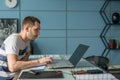 Young business man working on laptop at his desk in the office Royalty Free Stock Photo