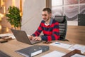 Business man working on a laptop at his desk in the office Royalty Free Stock Photo