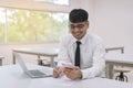 Young business man working at office with laptop, mobile and documents. Royalty Free Stock Photo