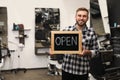 Young business owner holding OPEN sign in barber shop Royalty Free Stock Photo