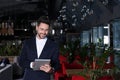 Young business owner with tablet in cafe. Space for text Royalty Free Stock Photo