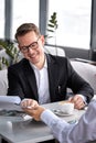 young business partners discuss future plan, strategy, idea sitting in restaurant Royalty Free Stock Photo