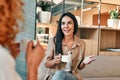 Young business partners drinking coffee in coffeeshop Royalty Free Stock Photo