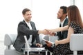 Young business partners shaking hands before starting a business meeting Royalty Free Stock Photo