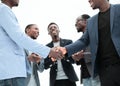 Young business partners shaking hands to applause of employees Royalty Free Stock Photo