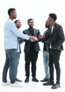 Young business partners shaking hands to applause of employees Royalty Free Stock Photo