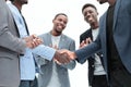 Young business partners shaking hands to applause of employees Royalty Free Stock Photo