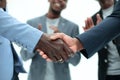 Young business partners shaking hands to applause of employees Royalty Free Stock Photo