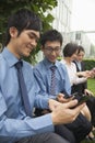 Young business people checking their cell phones Royalty Free Stock Photo