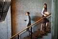 Young business people climb the stairs in the office building Royalty Free Stock Photo