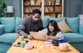 Young business people, couple, new business owners, working online from home, looking at laptop screen, having problems with Royalty Free Stock Photo