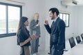 Young business people drinking champagne and talking in conference room Royalty Free Stock Photo